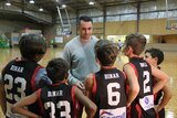 Adam Desmond with some of the Binar Sports Group basketball players.