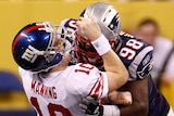 Manning gets crunched by the Patriots
