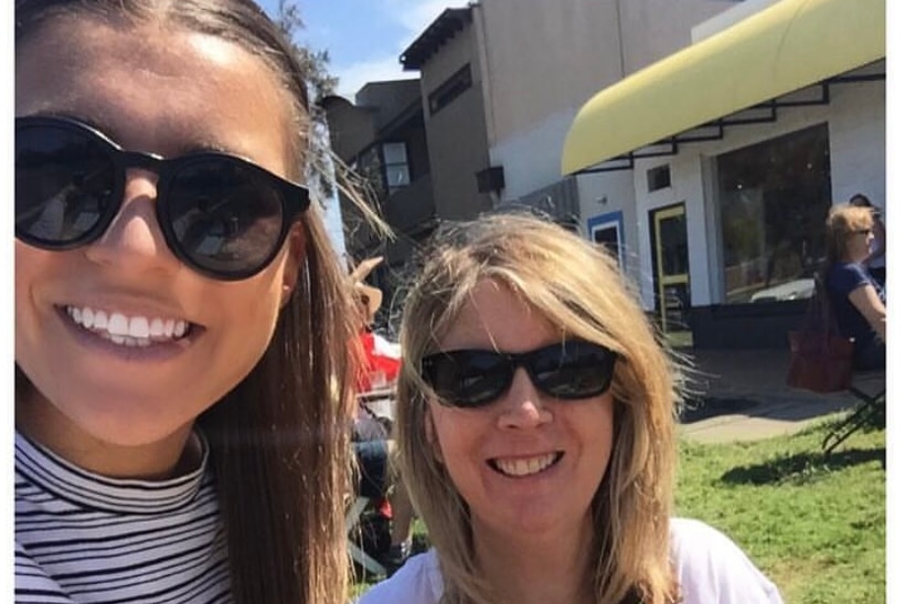 Steph Catley with her mum Lesley. Both are smiling and wearing sunglasses.