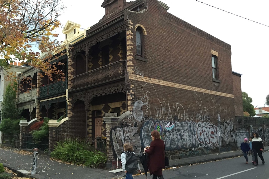 Graffiti covers the wall of a townhouse on Napier Street in Fitzroy