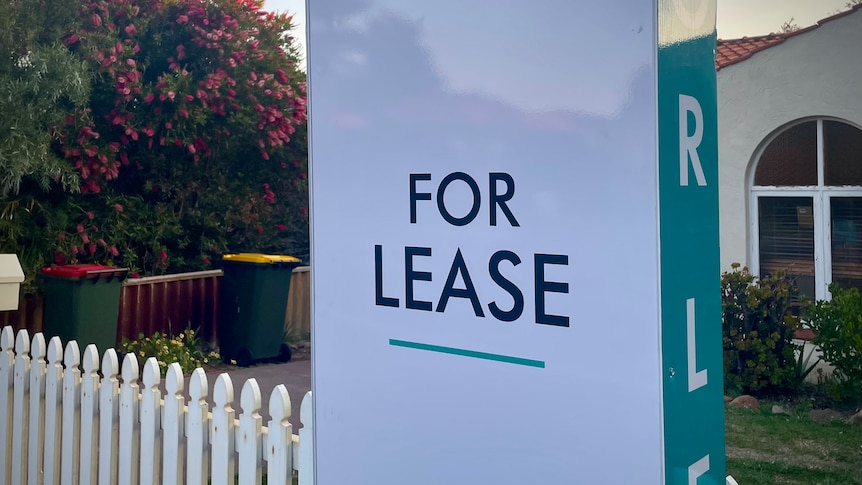 A for lease sign at a picket fence