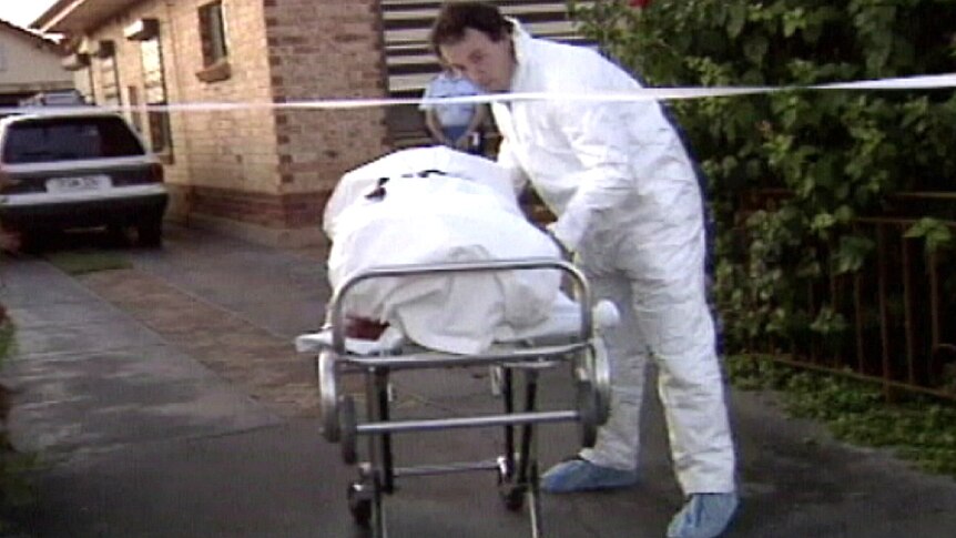 The body of Phyllis Harrison is wheeled out of her Elizabeth South home.