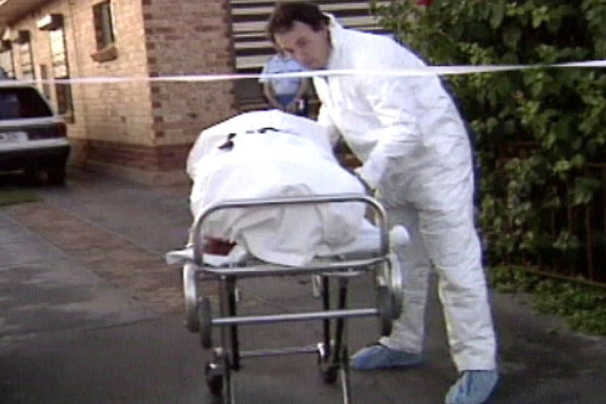 The body of Phyllis Harrison is wheeled out of her Elizabeth South home.
