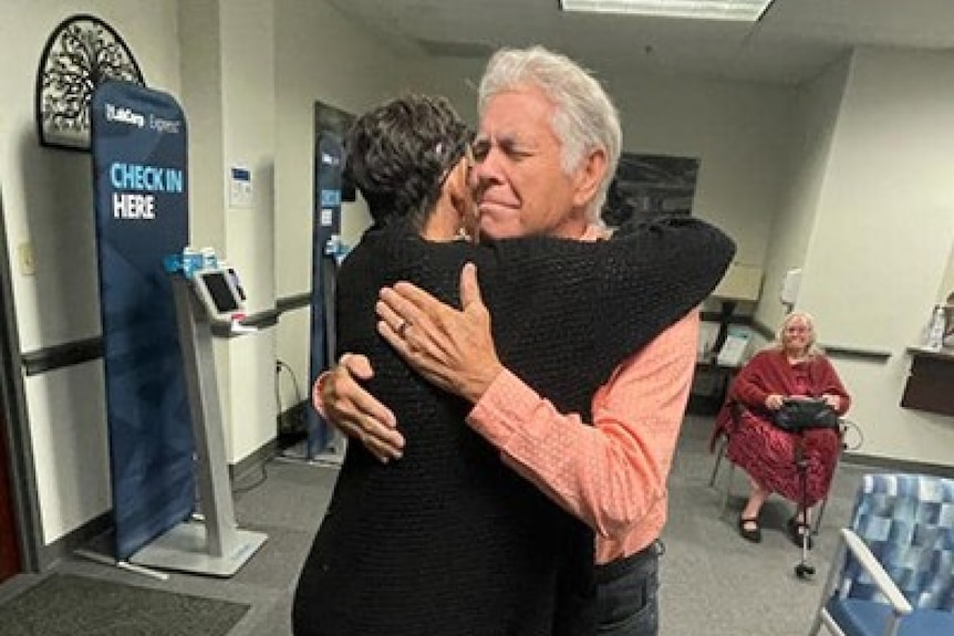 Melissa Highsmith hugs her biological father.