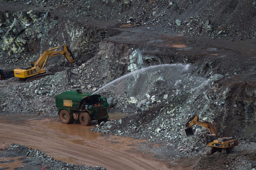 Trucks in a white asbestos mine