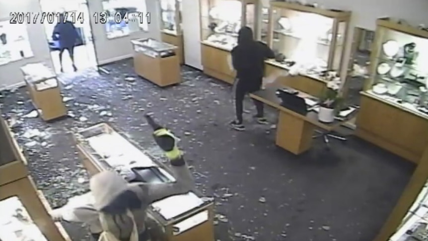 CCTV footage of a Toorak robbery shows the four men smashing counters in the store.