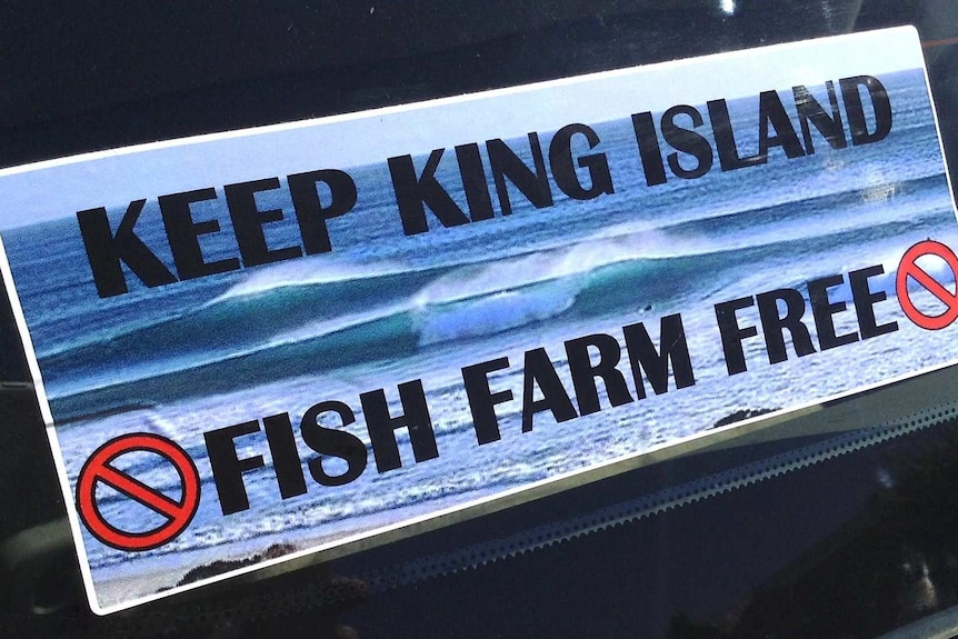 Sticker with message opposing salmon farming at King Island.