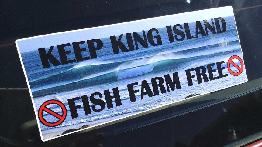 Sticker with message opposing salmon farming at King Island.