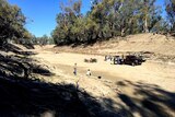 people with a four wheel drive and a barbecue on the completely dry river bed