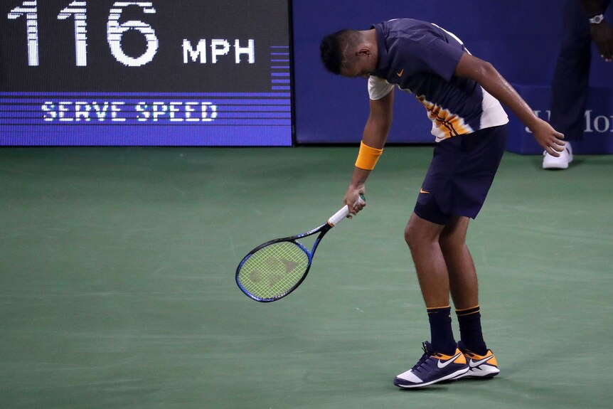 Nick Kyrgios walking with his down behind the baseline at the US Open.
