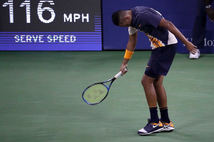 Nick Kyrgios walking with his down behind the baseline at the US Open.