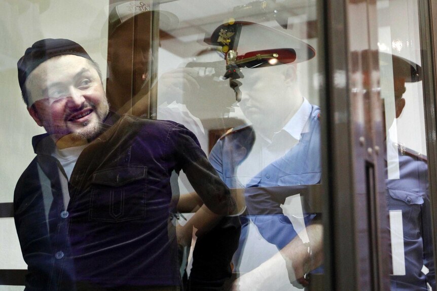 Rustam Makhmudov is escorted into court.