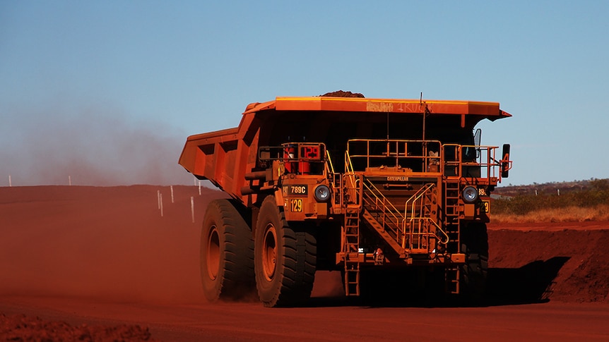 A truck hauls iron ore