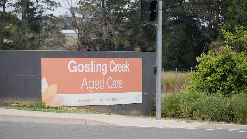 Sign with orange background reading Gosling Creek Aged Care in white writing 