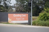 Sign with orange background reading Gosling Creek Aged Care in white writing 