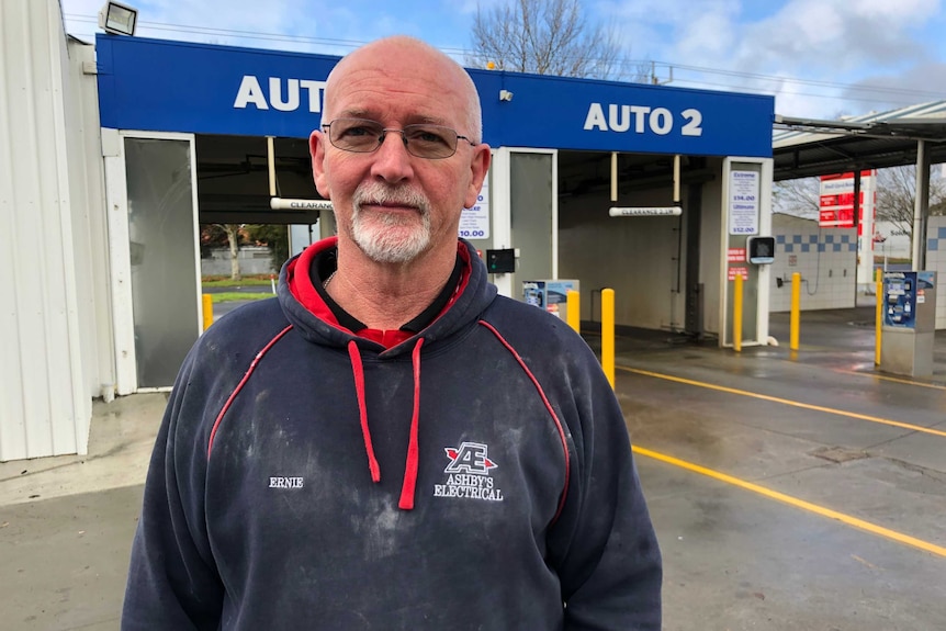 Ernie Corry standing in front of a car wash