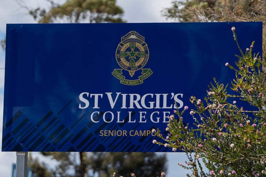A blue school sign which reads "St Virgil's College".