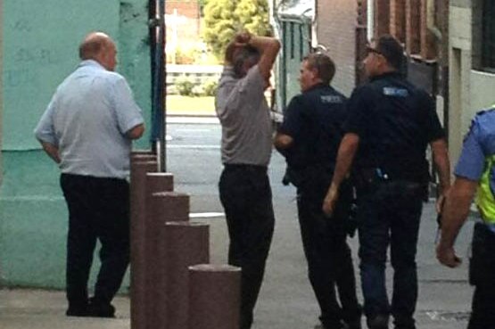 Serco guards talk to police after a detainee escaped