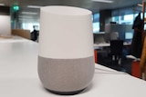 Google Home speaker on desk.