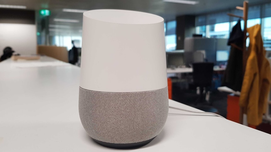 Google Home speaker on desk.