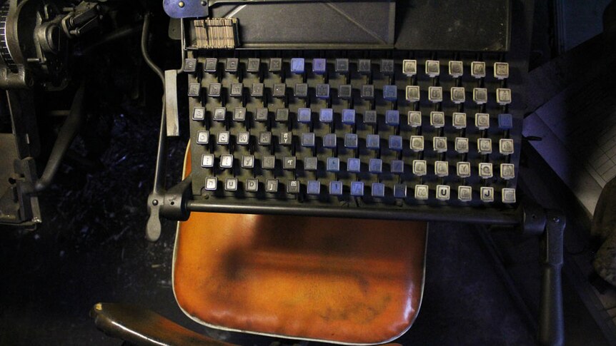 Bird's-eye view of the linotype keyboard with blue and white buttons.
