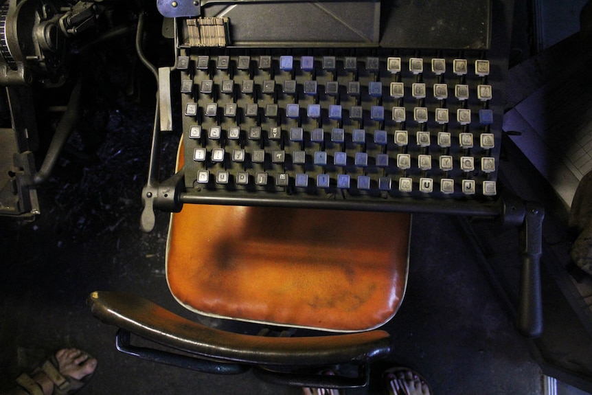 Bird's-eye view of the linotype keyboard with blue and white buttons.