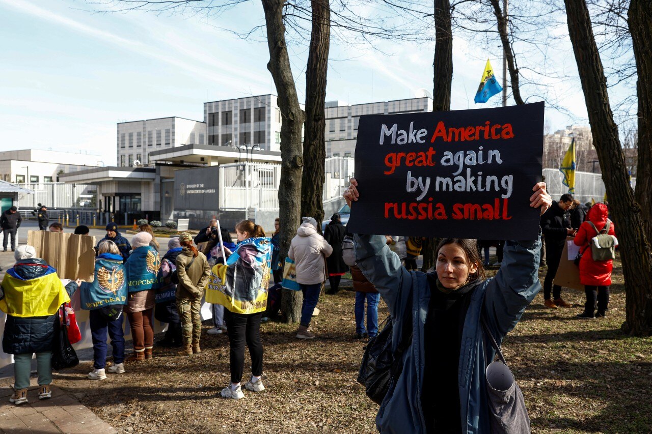 Several protesters, including some holding signs