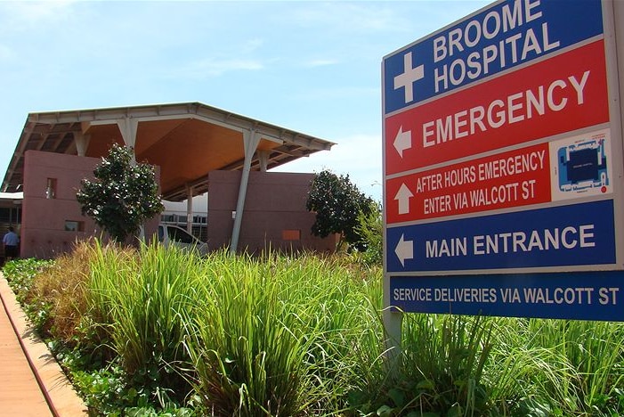 Exterior of a building signposted Broome Hospital, with arrows pointing to emergency and main entrance.