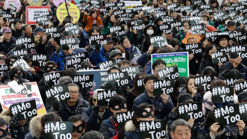 A large crowd made up of people holding placards that read #MeToo