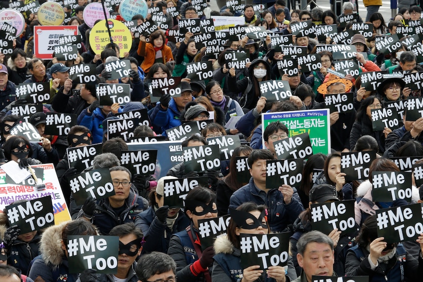 A large crowd made up of people holding placards that read #MeToo