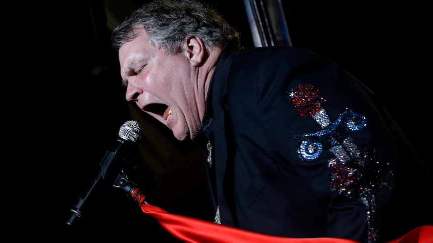 Meat Loaf singing into a microphone.