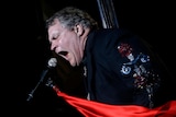 Meat Loaf singing into a microphone.