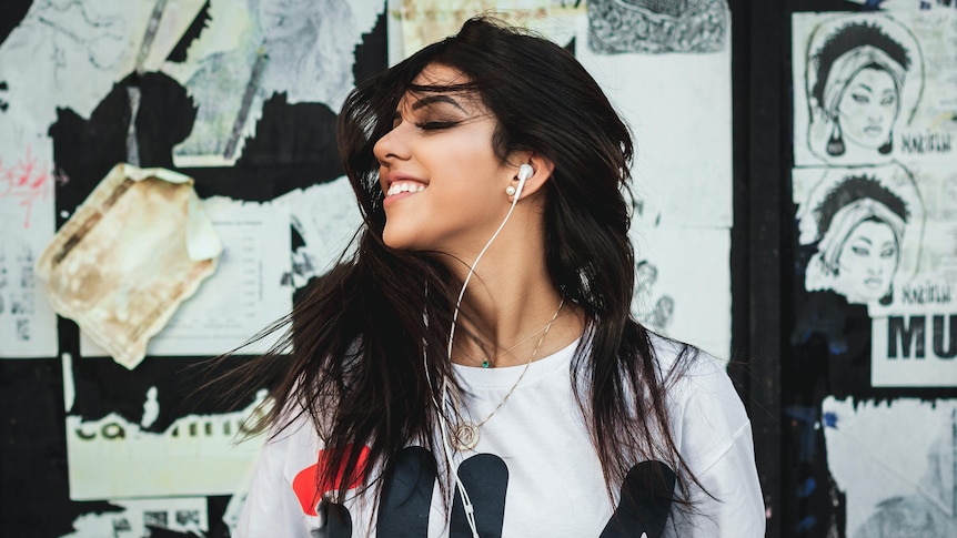Person with earphones smiling