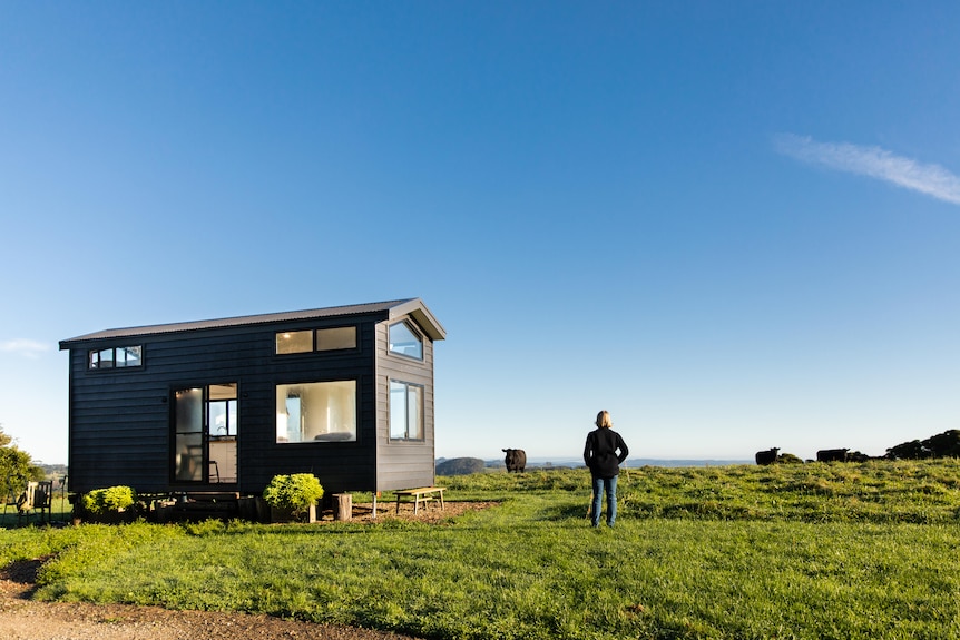 A tiny house on a grassy block of land