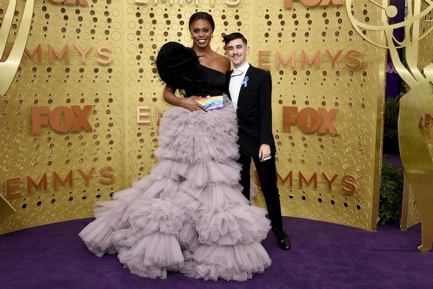 Laverne and Chase pose together on the purple carpet