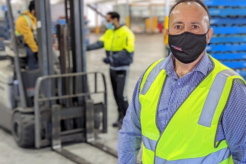 a man in high-vis in a logistics warehouse