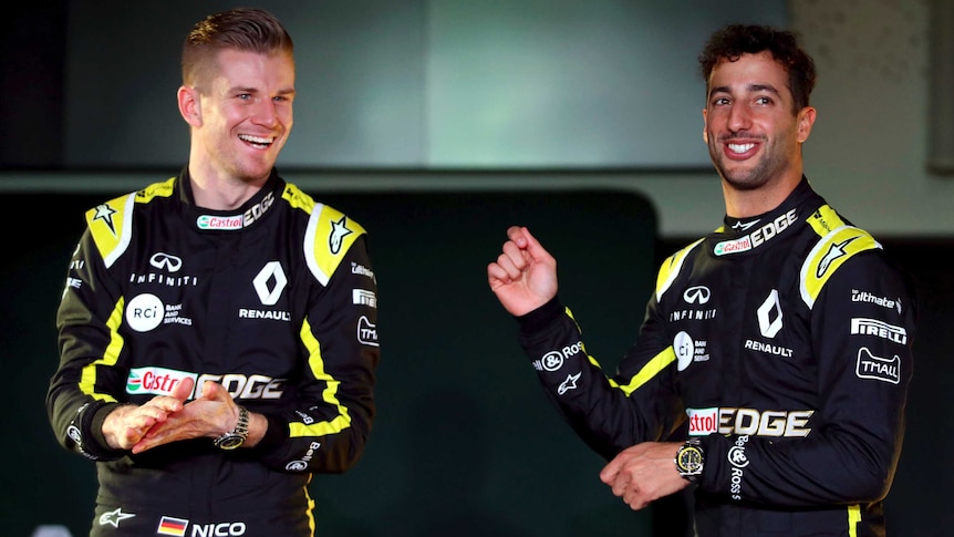 Two F1 drivers smile for the cameras at a season launch.