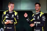 Two F1 drivers smile for the cameras at a season launch.