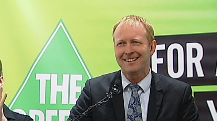 Greg Barber speaks at a podium.