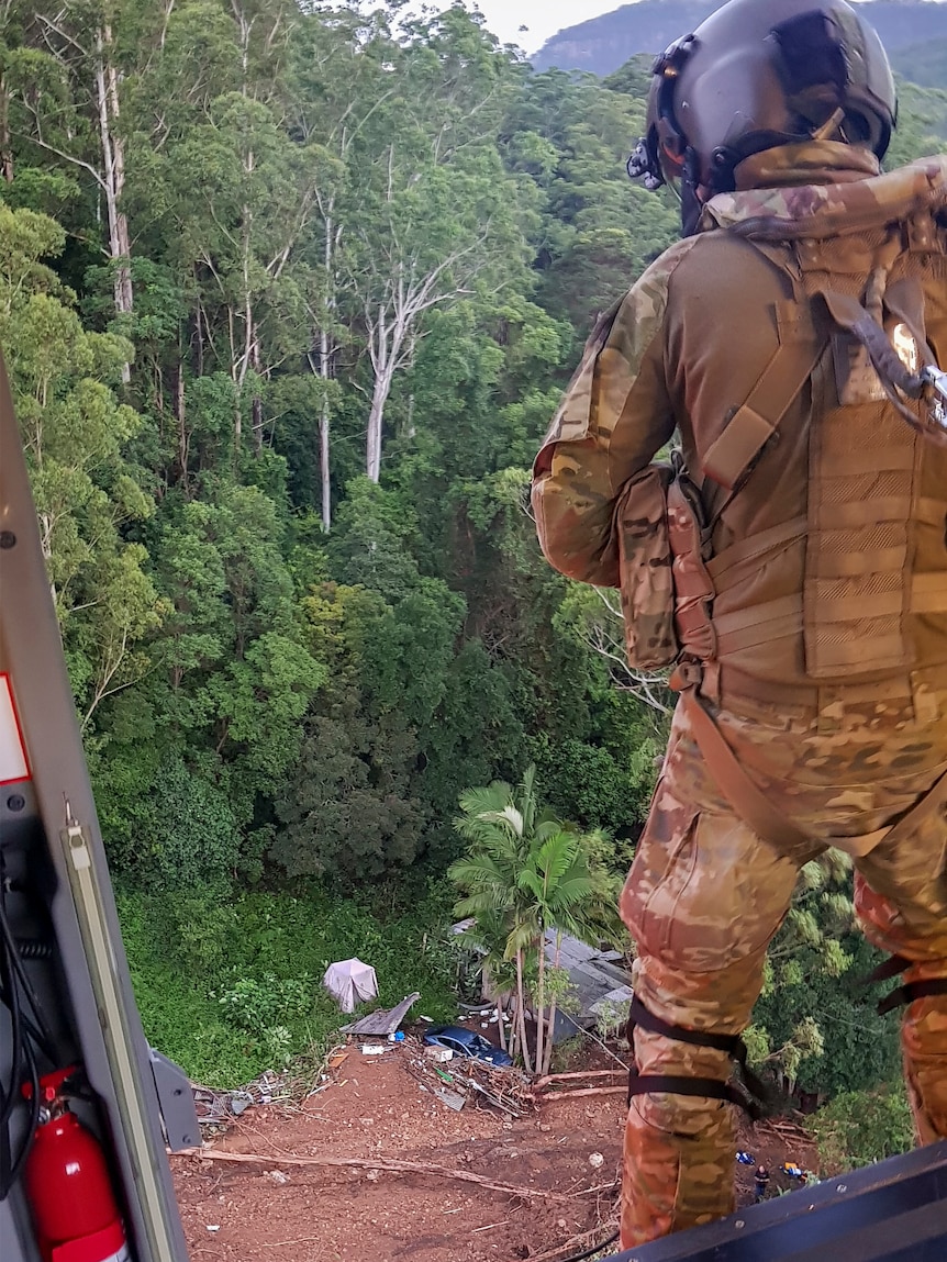 An Australian Army Loadmaster assesses the terrain for an evacuation mission.