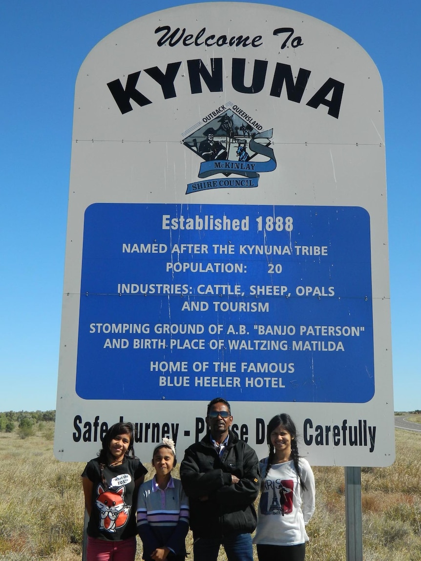 Destiny as a child pictured with her father and younger female relatives in front of a Kynuna sign. 