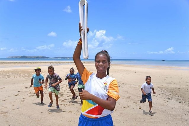 The community on Palm Island comes together with the Commonwealth Games baton.