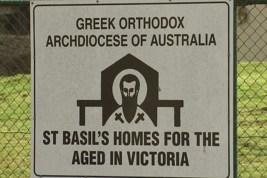 A sign for the St Basil's Greek Orthodox aged care home in Fawkner attached to a wire fence.