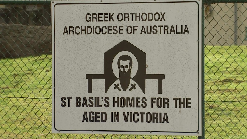 A sign for the St Basil's Greek Orthodox aged care home in Fawkner attached to a wire fence.