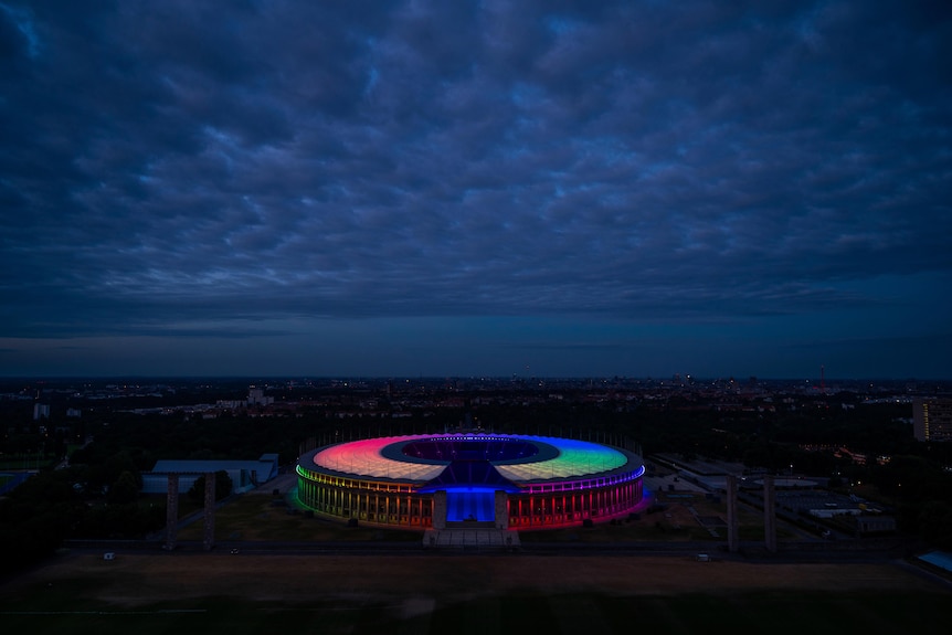 A series of colours appear around a stadium in Berlin as part of a statement of support for diversity and the LGBTQ community.