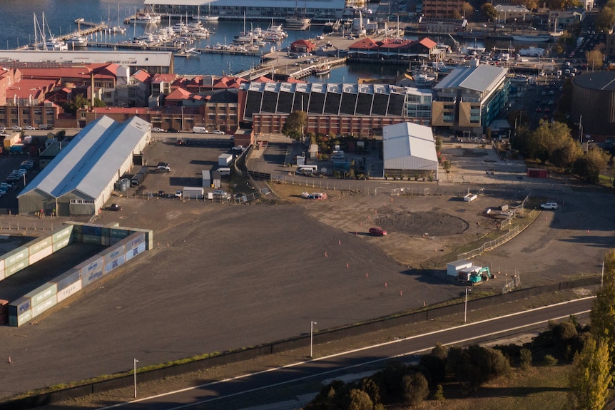 An aerial photo of a large, cleared construction site near the Hobart CBD, by the waterfront.