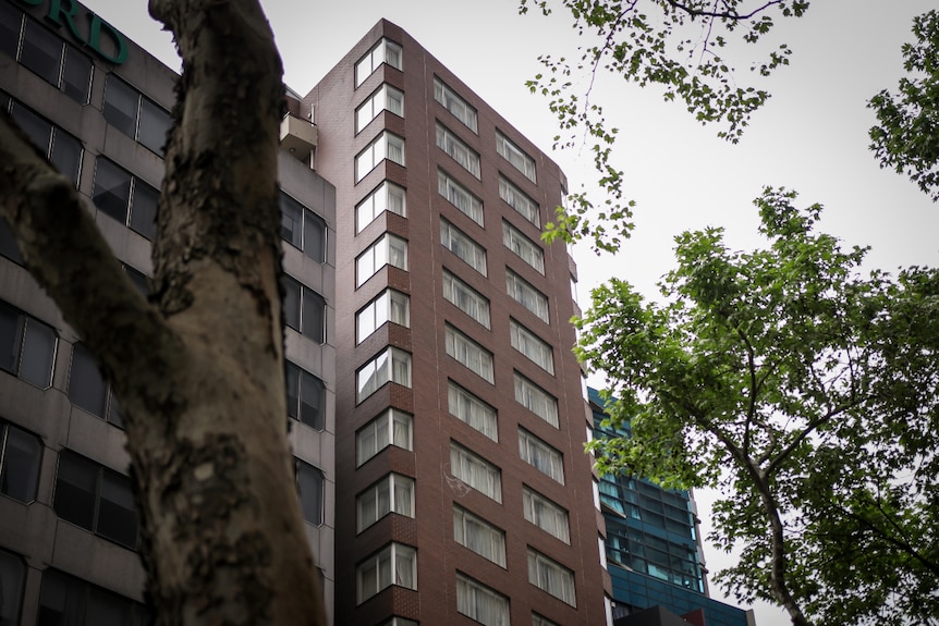 A brown high-rise hotel.