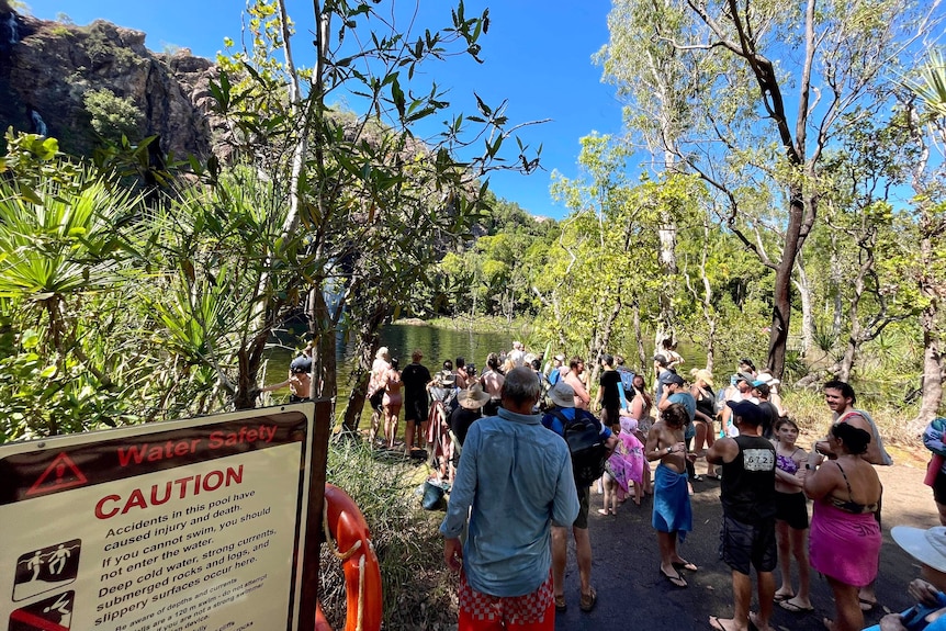 Crowds stand by the water's edge