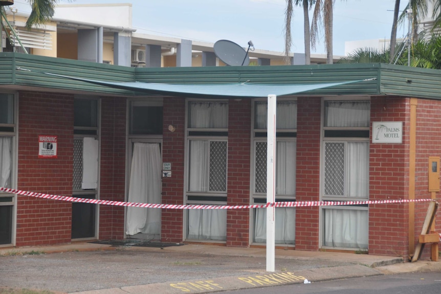 Broken glass and a spent shotgun cartridge are visible at the crime scene at the Palms Motel.