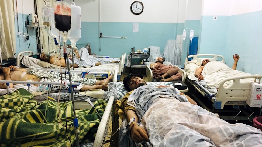 Afghans lie on beds at a hospital after they were wounded in the deadly attacks.
